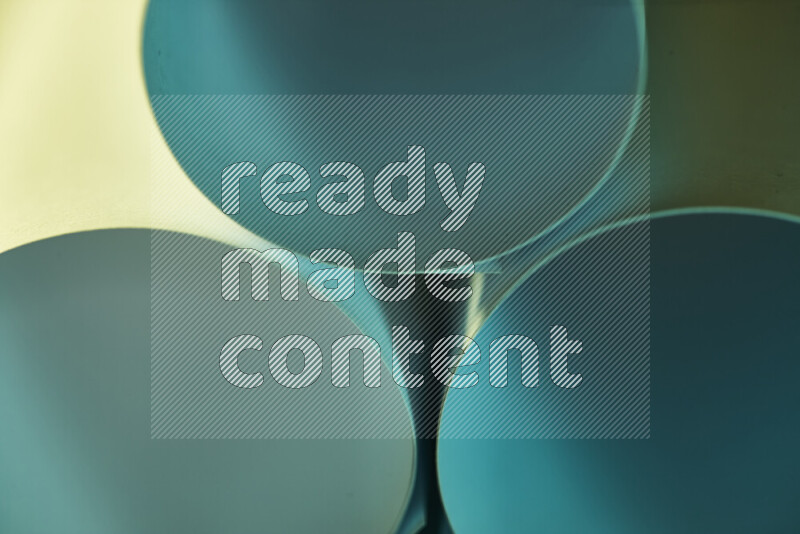 The image shows an abstract paper art with circular shapes in varying shades of green and warm tones