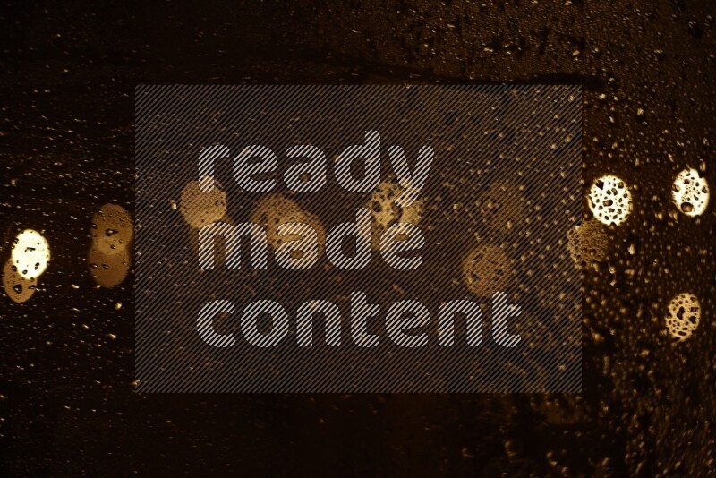 Bokeh light in yellow with water drops