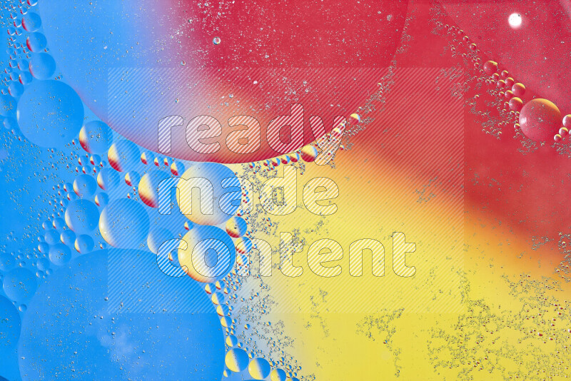 Close-ups of abstract oil bubbles on water surface in shades of yellow, red and blue