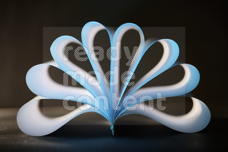An abstract art piece displaying smooth curves in blue and white gradients created by colored light
