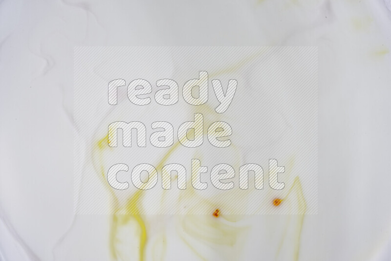 A close-up of abstract swirling patterns in yellow and white