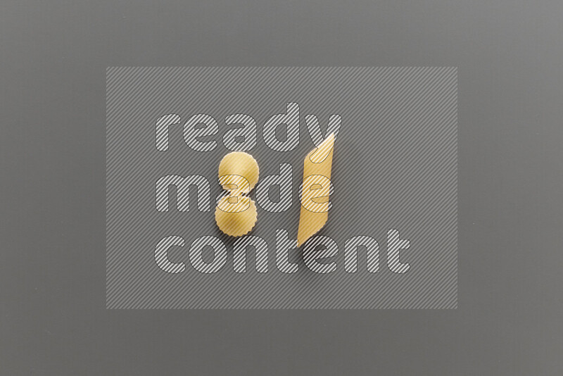 Fiocchi pasta with other types of pasta on grey background