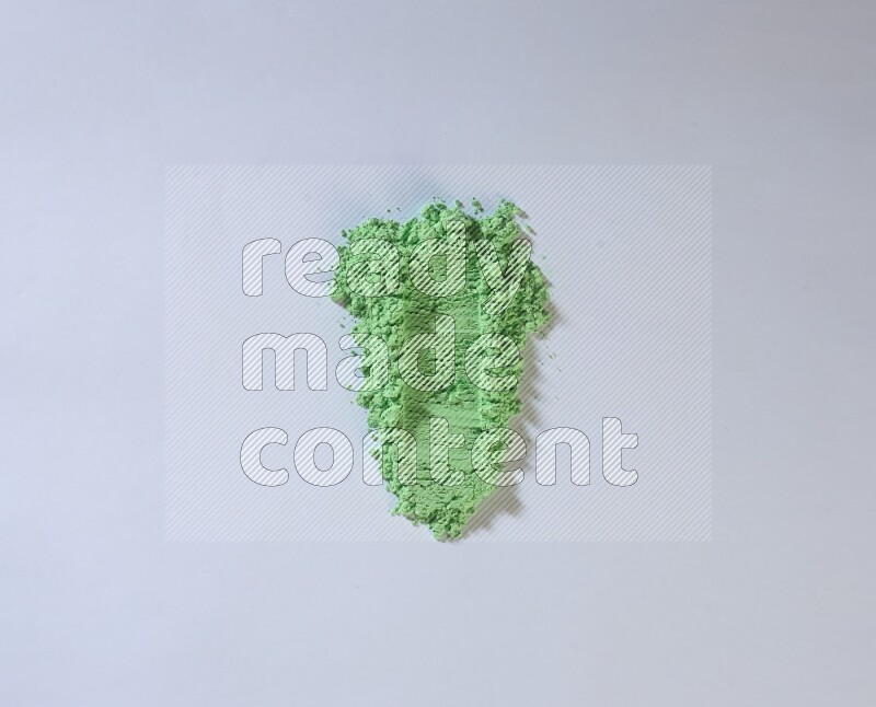 Green powder smears on white background