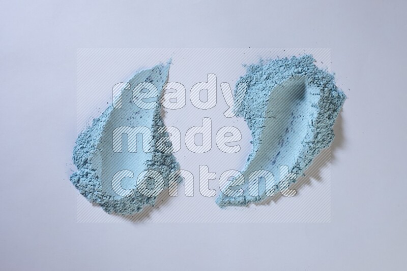 Blue powder smears on white background