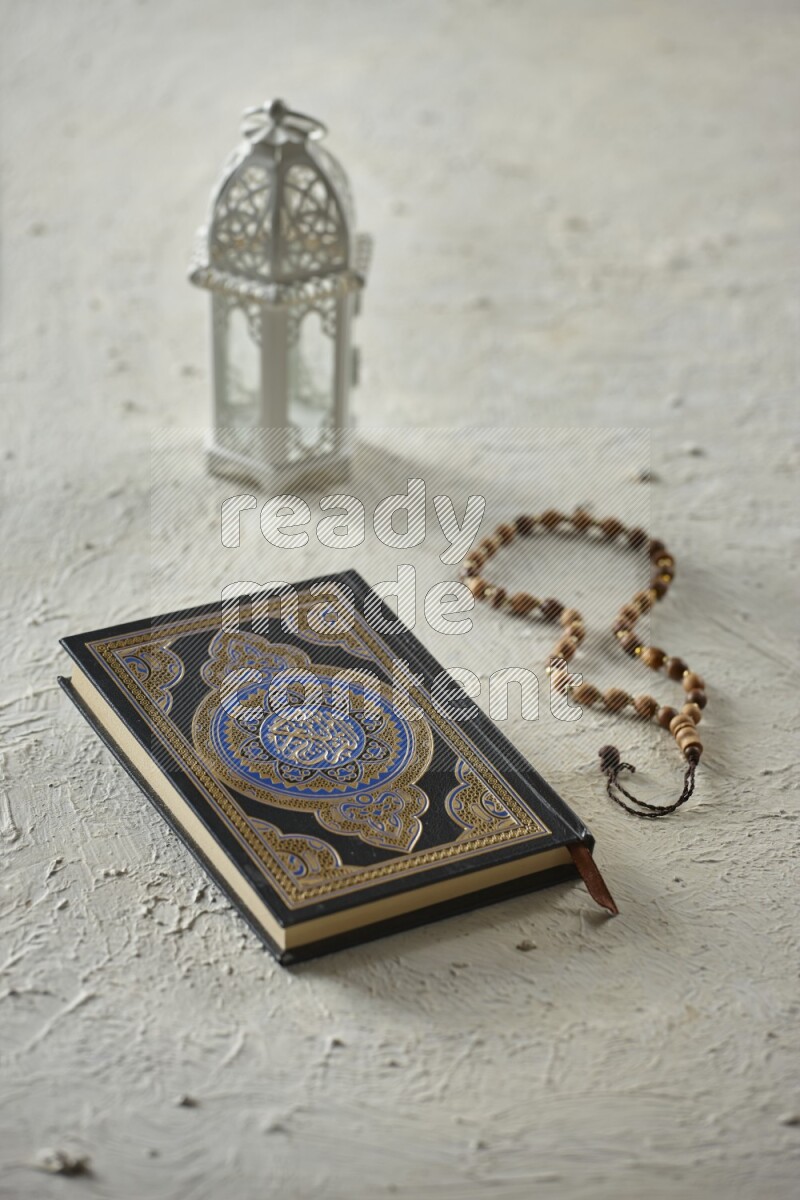 A white lantern with different drinks, dates, nuts, prayer beads and quran on white background