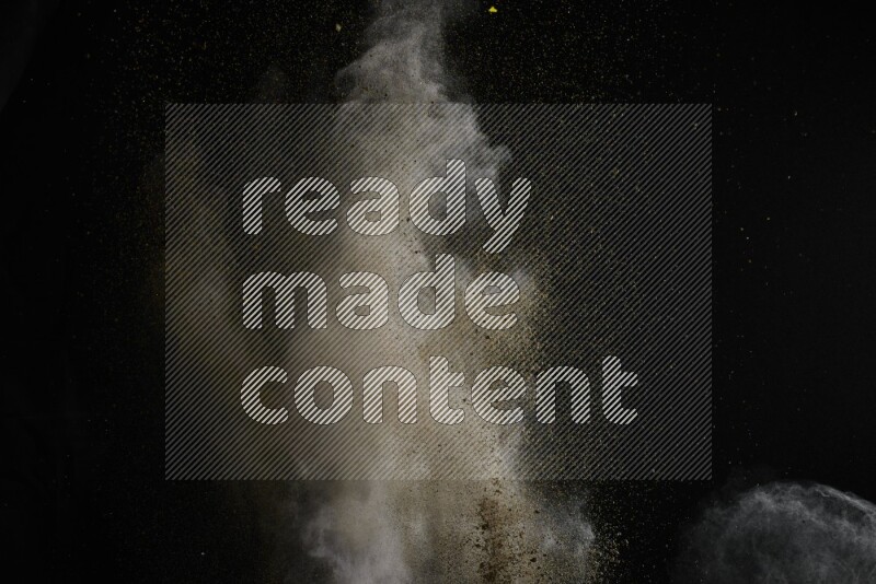 A side view of brown powder explosion on black background