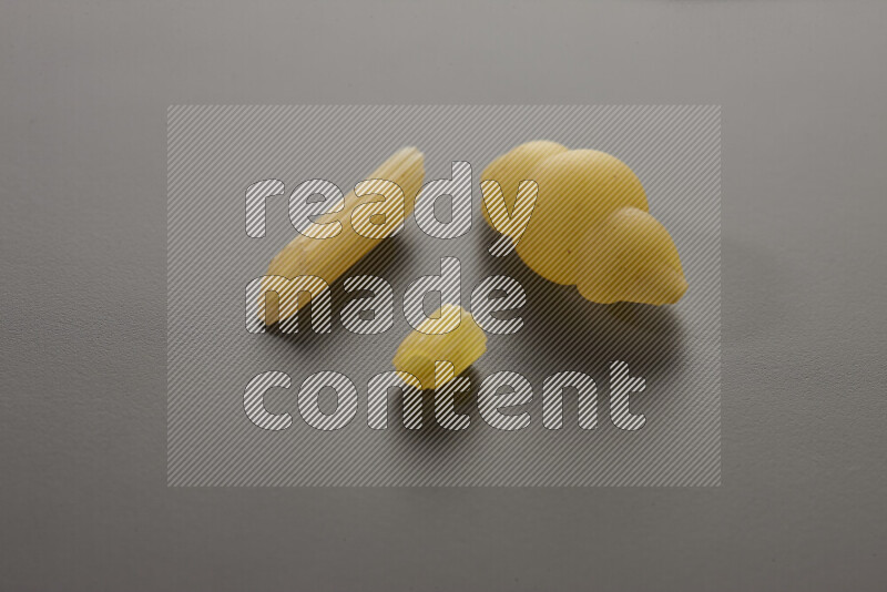Different pasta types on grey background