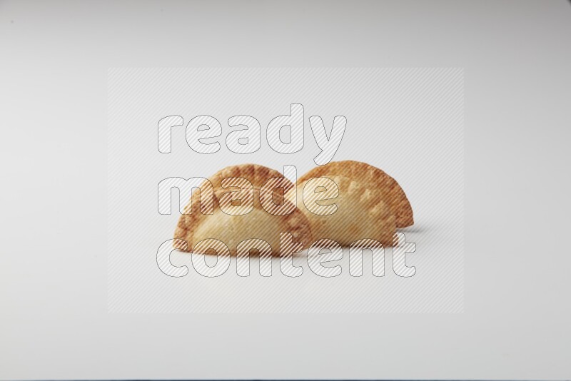 Four fried sambosas on a white background