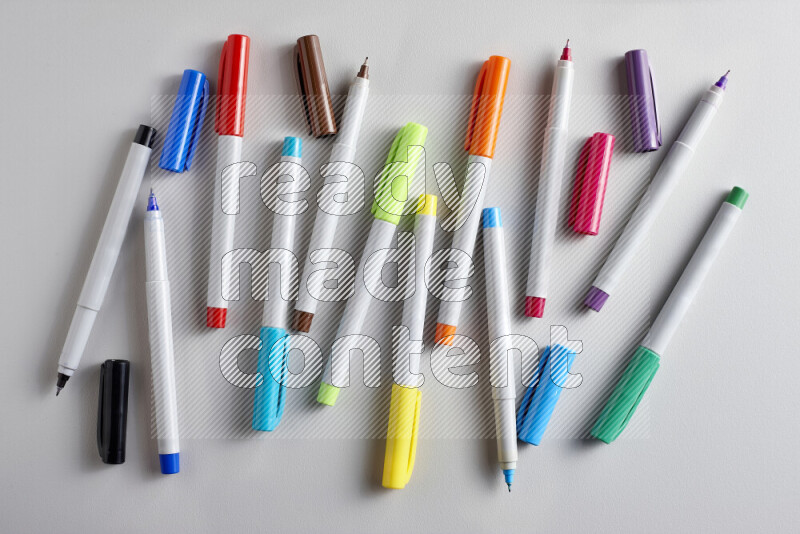 An arrangement of coloring pens in different colors on grey background