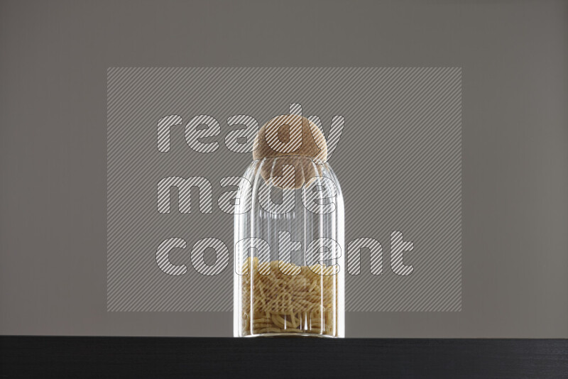 Snacks in a glass jar on black background