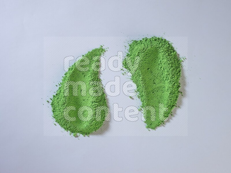 Green powder smears on white background