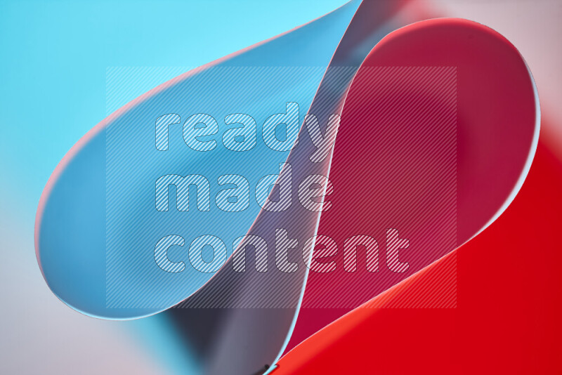 An abstract art of paper folded into smooth curves in blue and red gradients
