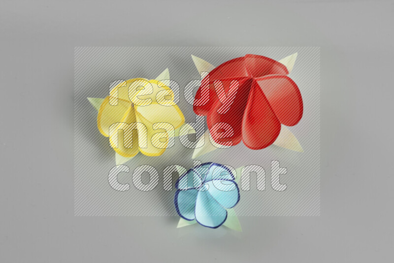 Origami flower on grey background