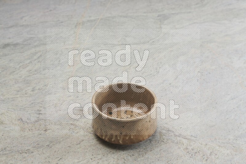 A multicolored pottery bowl on grey marble background