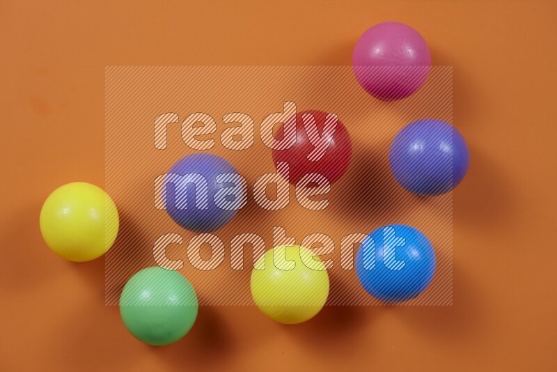 Multicolored plastic balls on different colored backgrounds (kids toys)