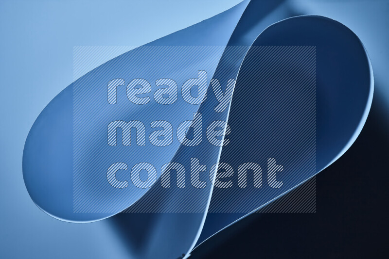 An abstract art of paper folded into smooth curves in blue gradients