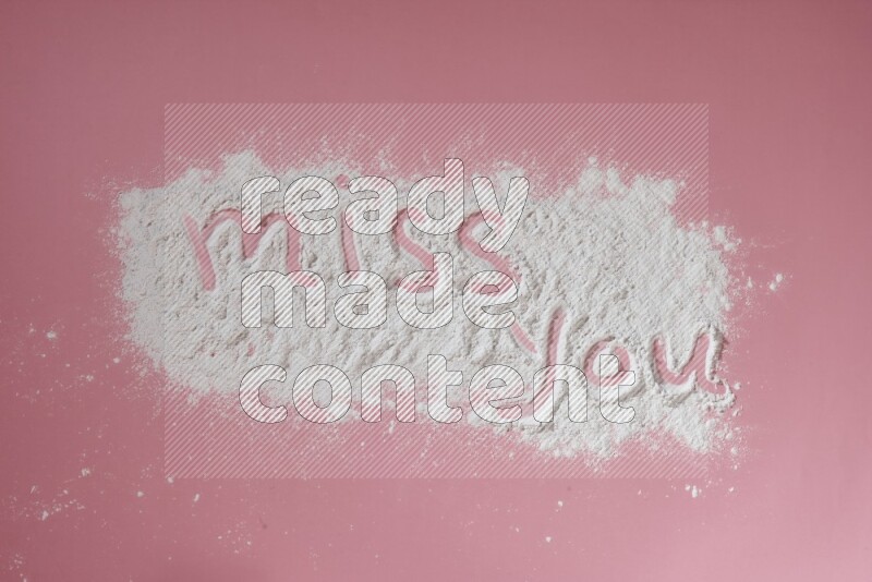 A sentence written with powder on pink background