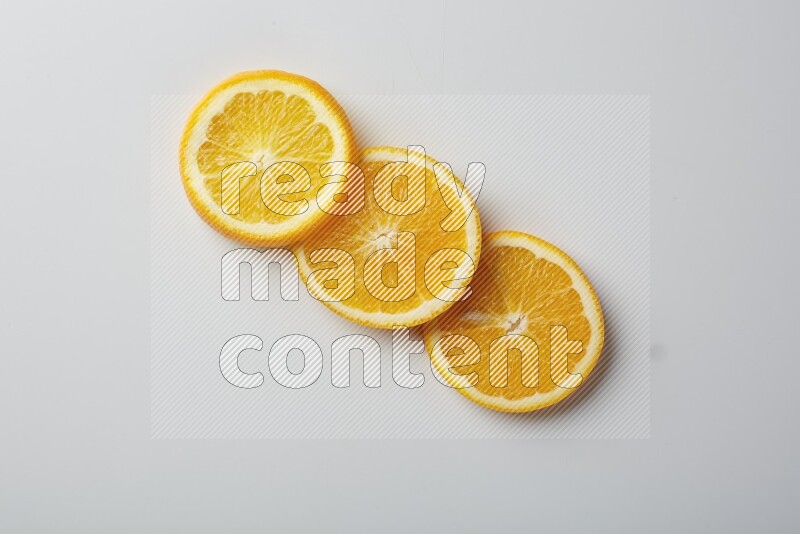 Three orange slices on a white background