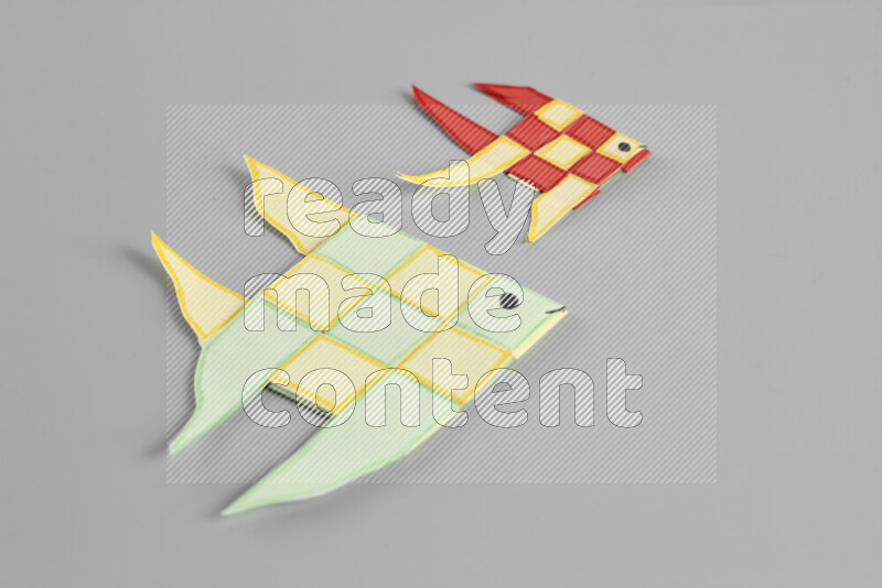 Origami fish on grey background