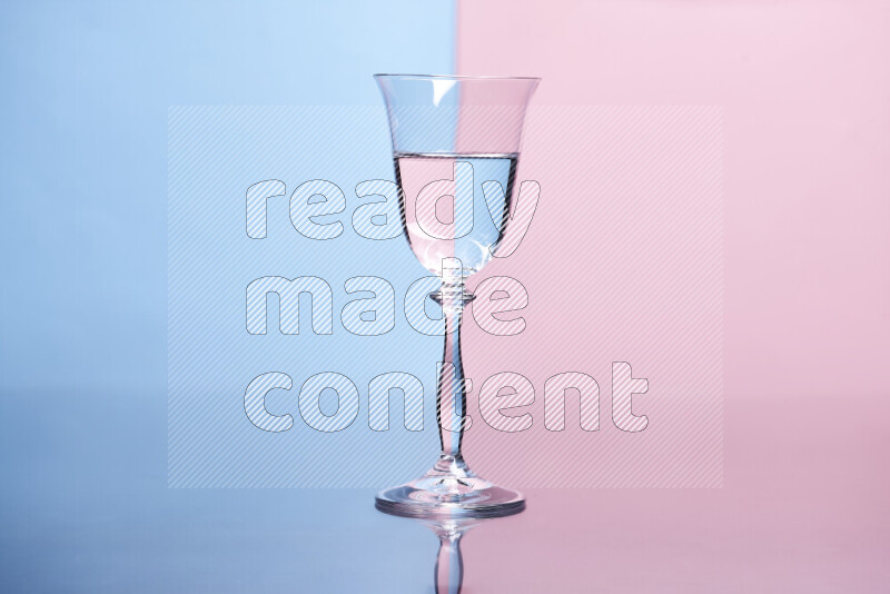 The image features a clear glassware filled with water, set against light blue and rose background