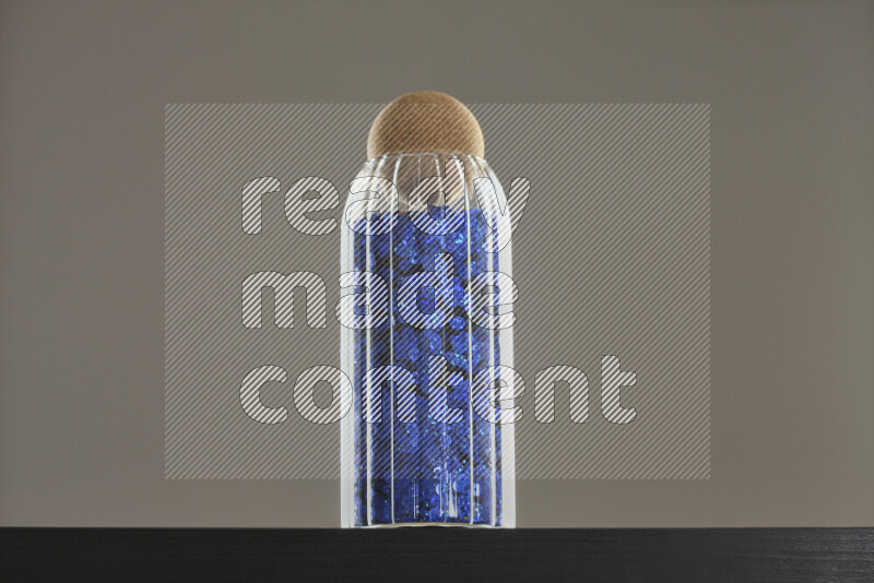 ترتر ملون في وعاء زجاجي علي خلفية سوداء