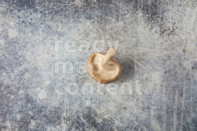 single fresh shiitake Mushroom topview  on a blue textured background