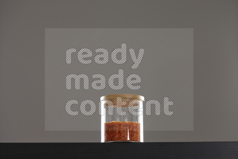 Lentils in a glass jar on black background