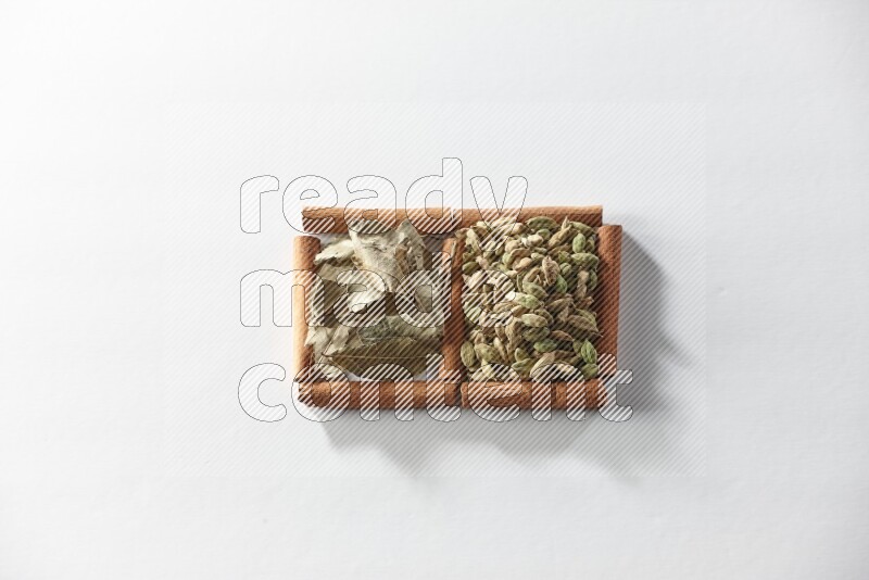 2 squares of cinnamon sticks full of cardamom and bay laurel leaves on white flooring