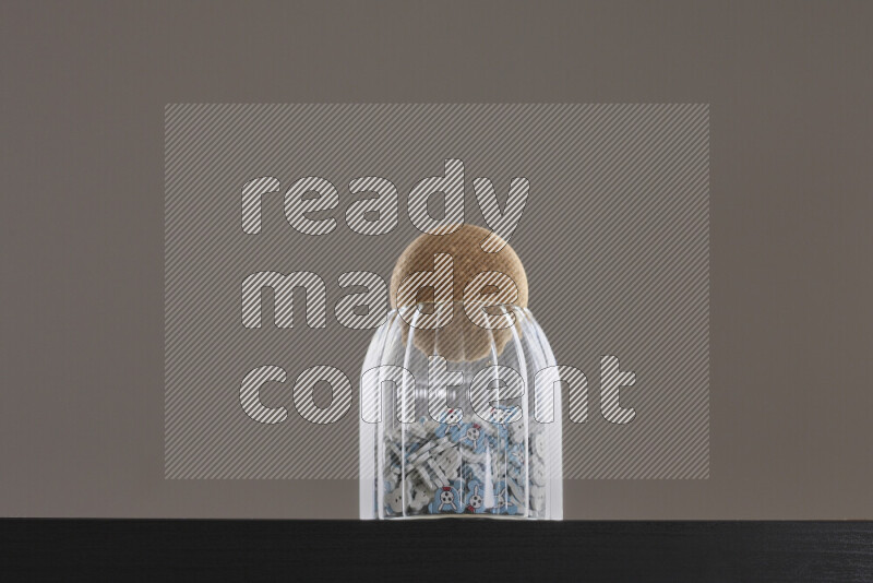 Buttons in a glass jar on black background