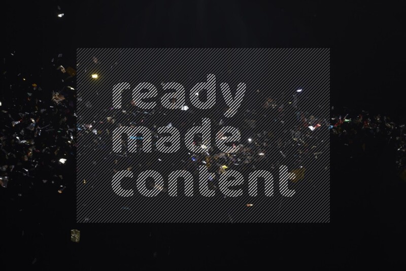 Falling multicolored confetti on black background