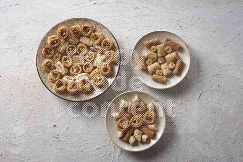 Oriental sweets in pottery plates in a light setup