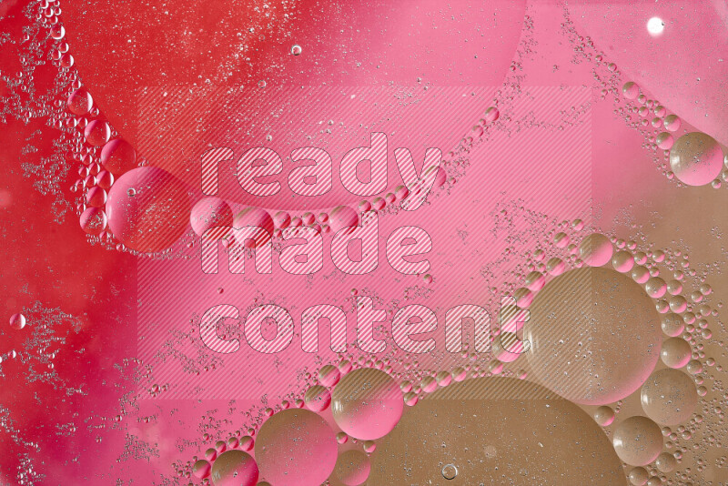 Close-ups of abstract oil bubbles on water surface in shades of brown, red and pink