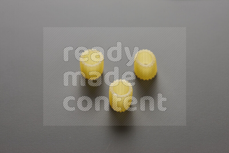 Big rings pasta on grey background