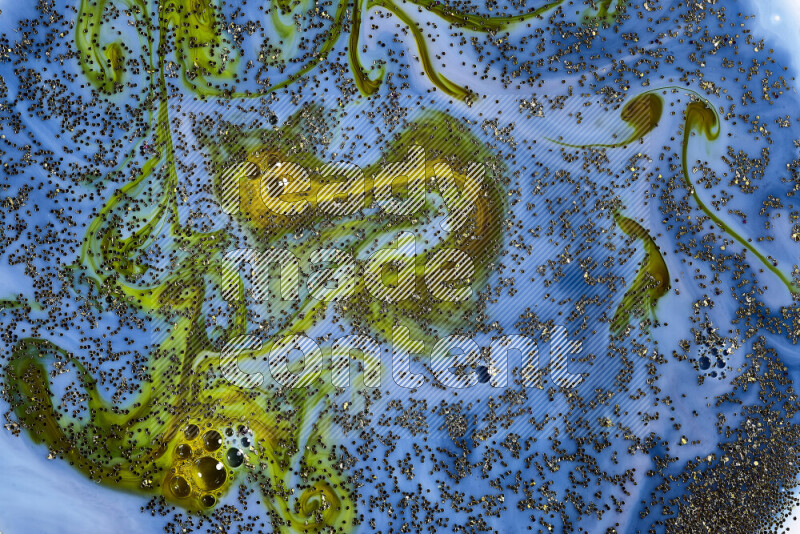 لقطة مقربة لبريق ذهبي متلألئ منتشر على خلفية من اللون الأزرق والأخضر في حركات دائرية