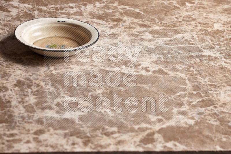 A vintage metal plate on beige marble background