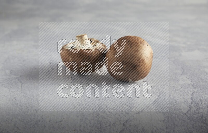 45 degre cremini  mushrooms on a textured light blue background