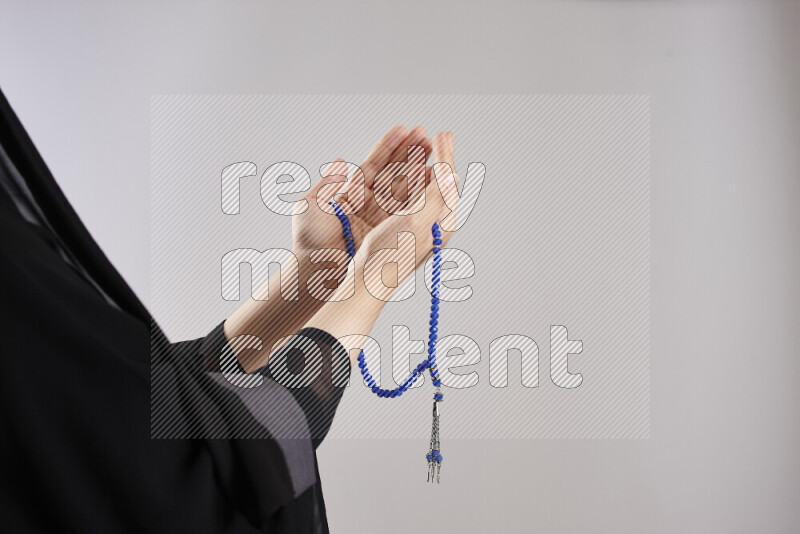 Woman hands holding praying beads (sebha) in different positions