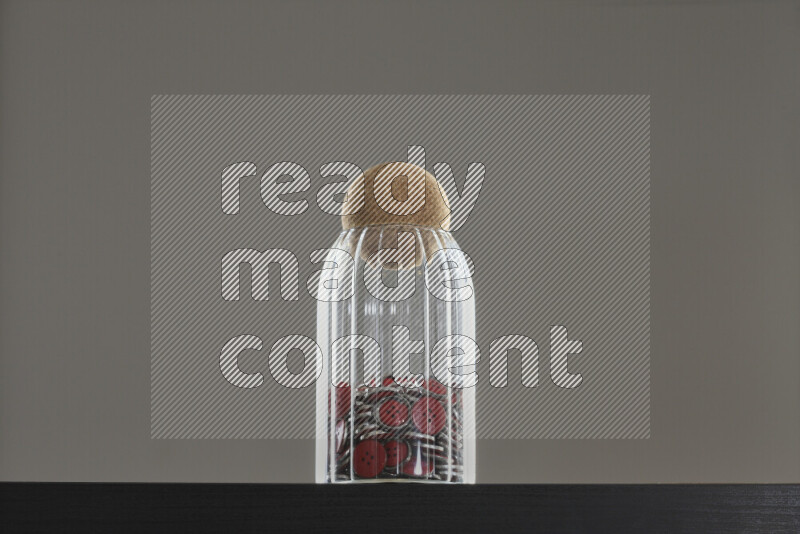 Buttons in a glass jar on black background