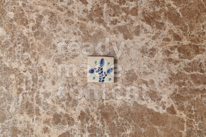 A decorative coaster on beige marble background