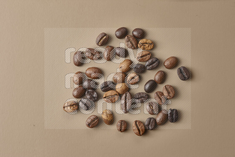 Roasted coffee beans on beige background