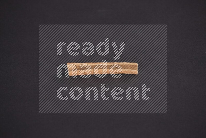 Cinnamon stick on black background