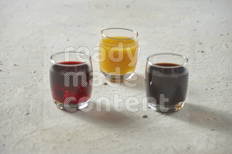 Cold drinks in a glass cup such as water, tamarind, qamar eldin, sobia, milk and hibiscus on textured white background