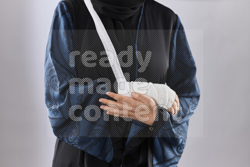 Woman with a bandaged hand and arm sling