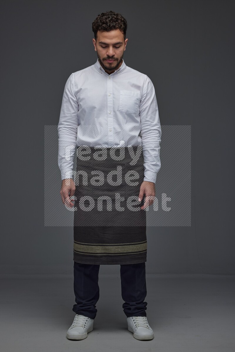 A man wearing smart casual and apron standing and making multi poses eye level on a gray background