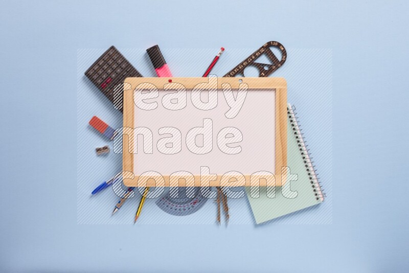 A whiteboard with assorted school supplies on blue background