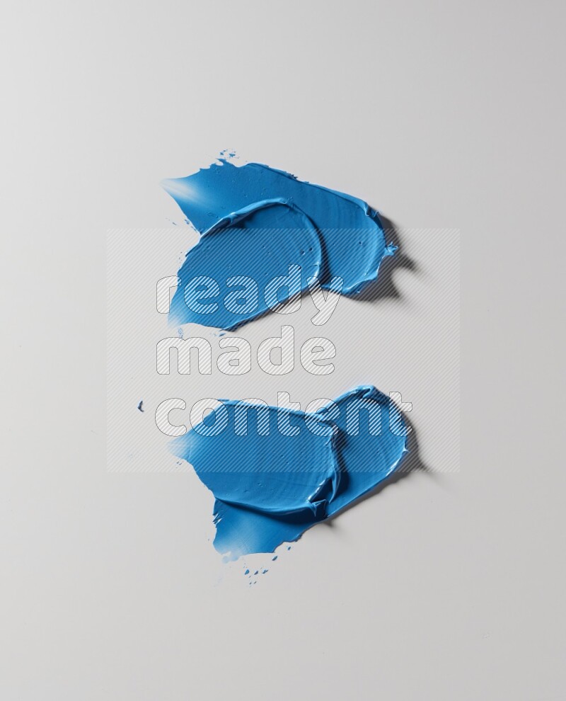 Blue painting knife strokes on white background