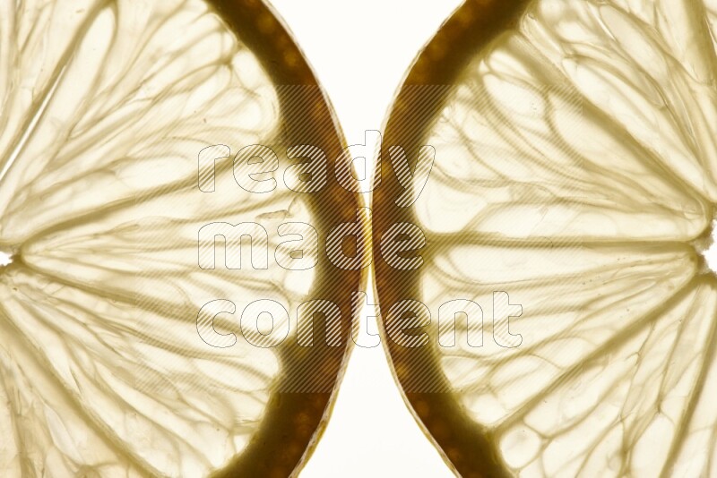 Lemon slices on illuminated white background