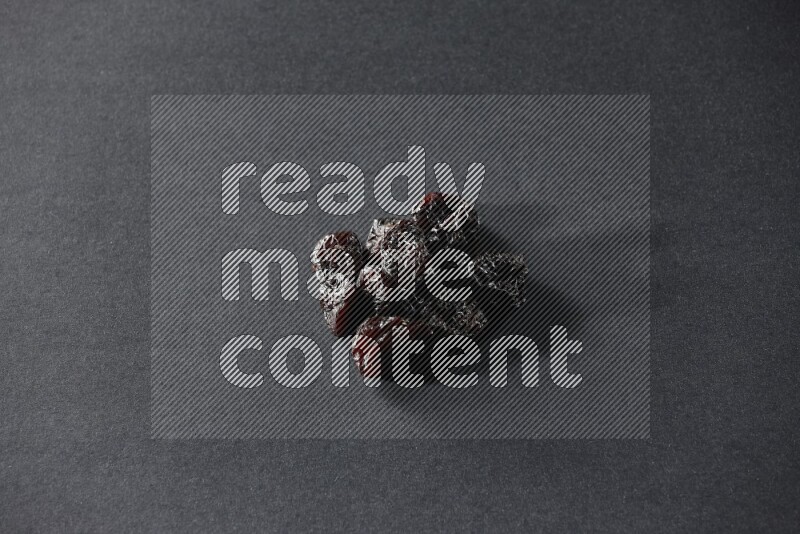 Dried plums on a black background in different angles