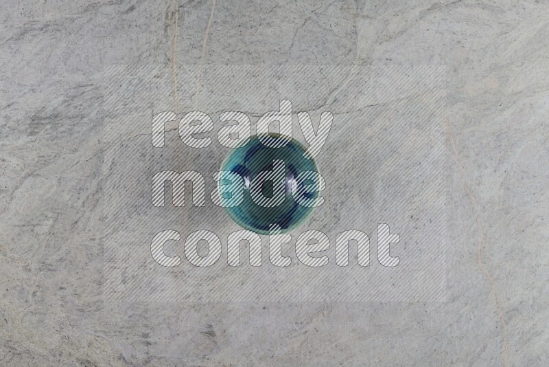 A multicolored pottery Bowl on grey marble background