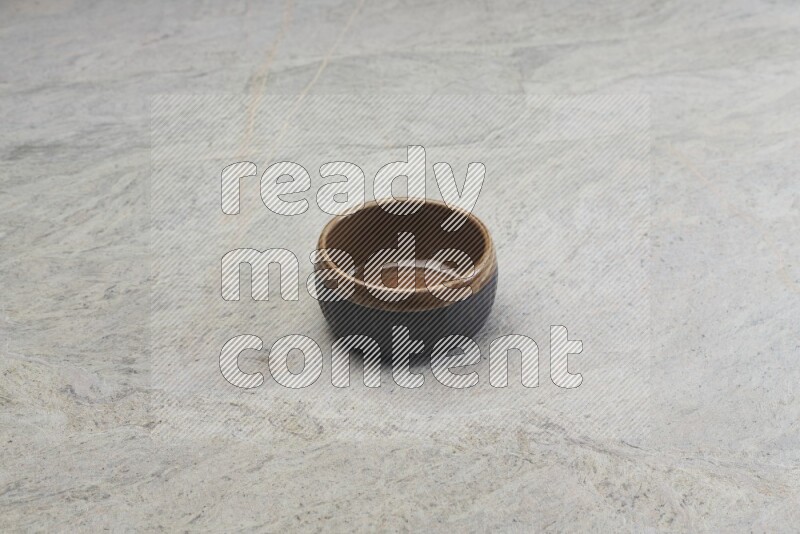A multicolored pottery bowl on grey marble background